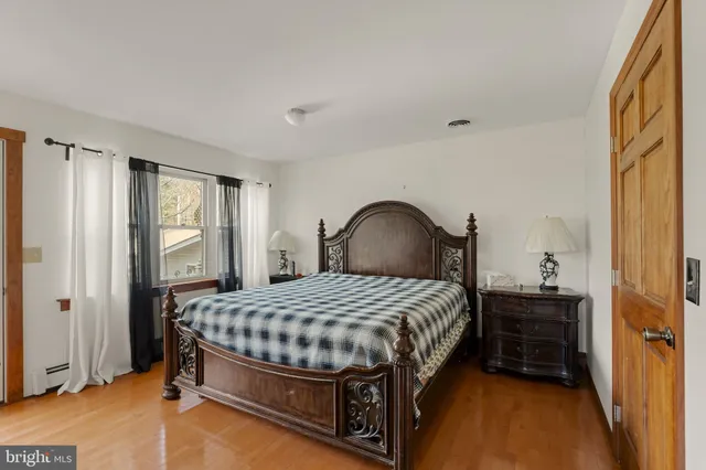 a view of a hallway with wooden floor and stairs