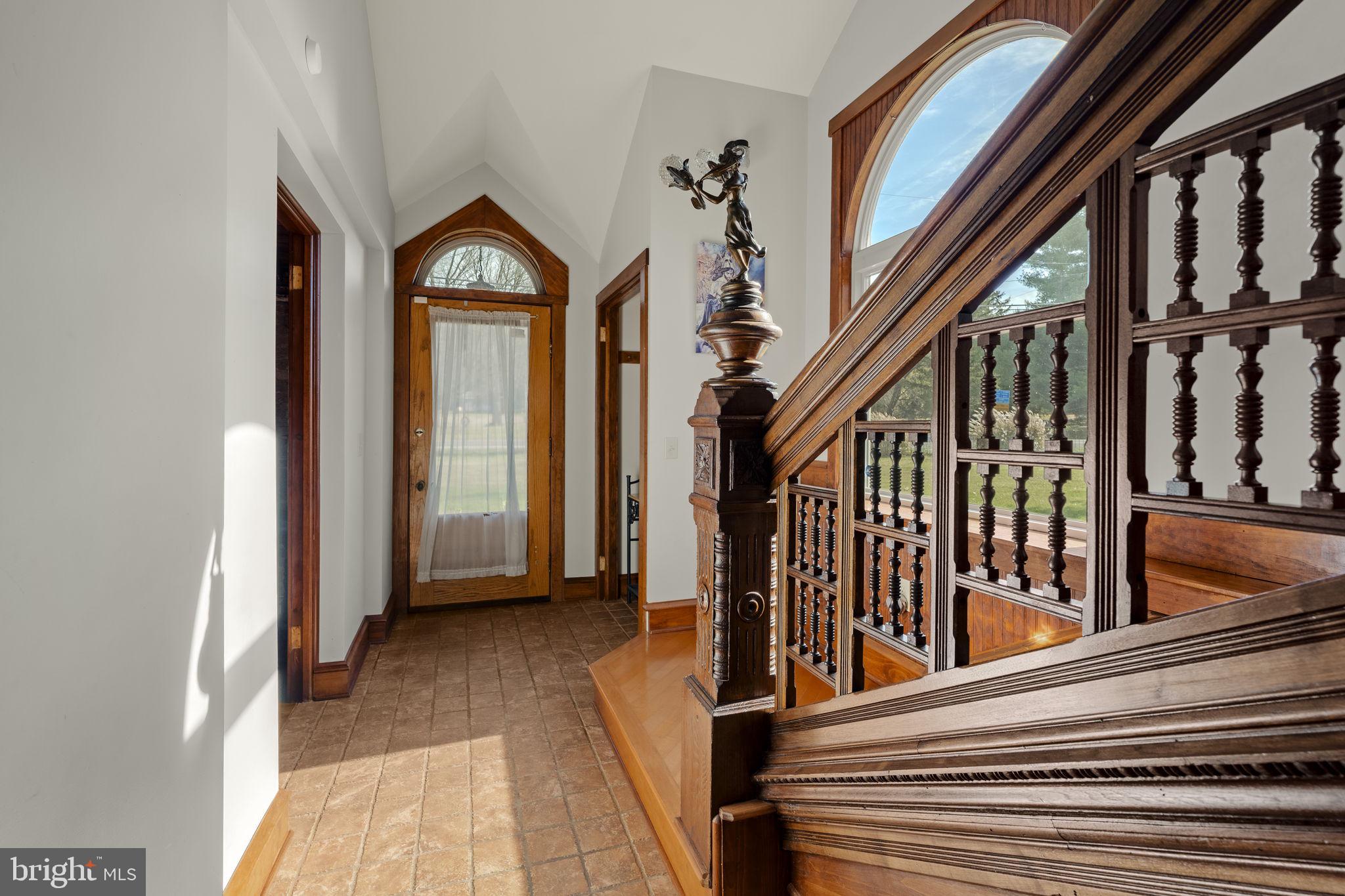 451 Pine Swamp Road Elverson, PA 19520 - Photo 23 of 91 a view of a hallway with wooden floor and stairs