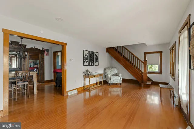 a view of a livingroom with a fireplace wooden floor and window