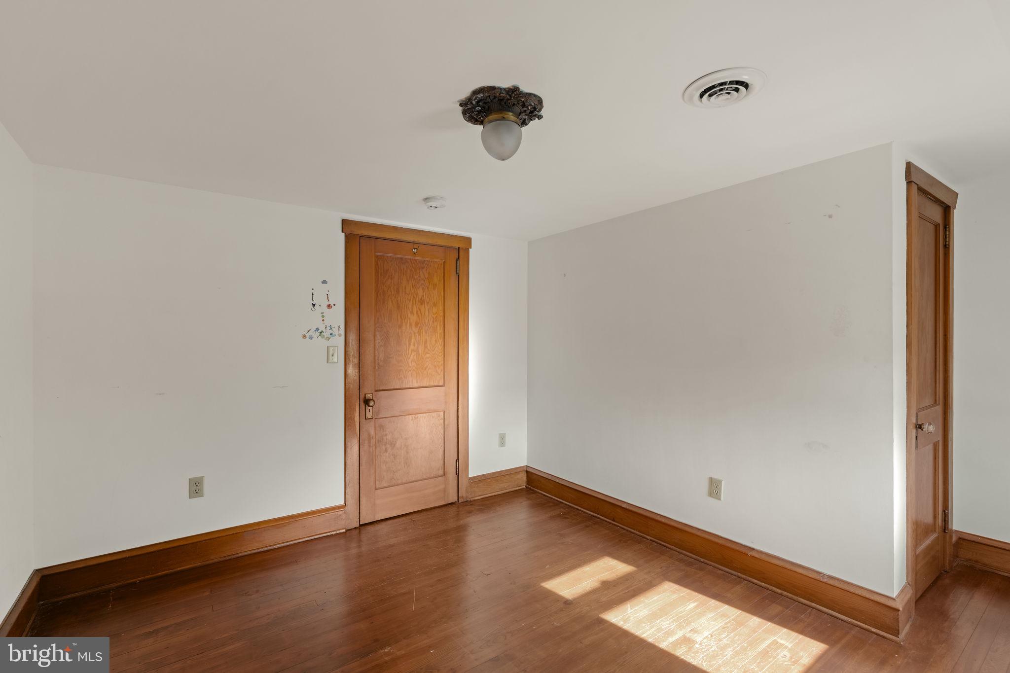 451 Pine Swamp Road Elverson, PA 19520 - Photo 35 of 91 a view of empty room with wooden floor