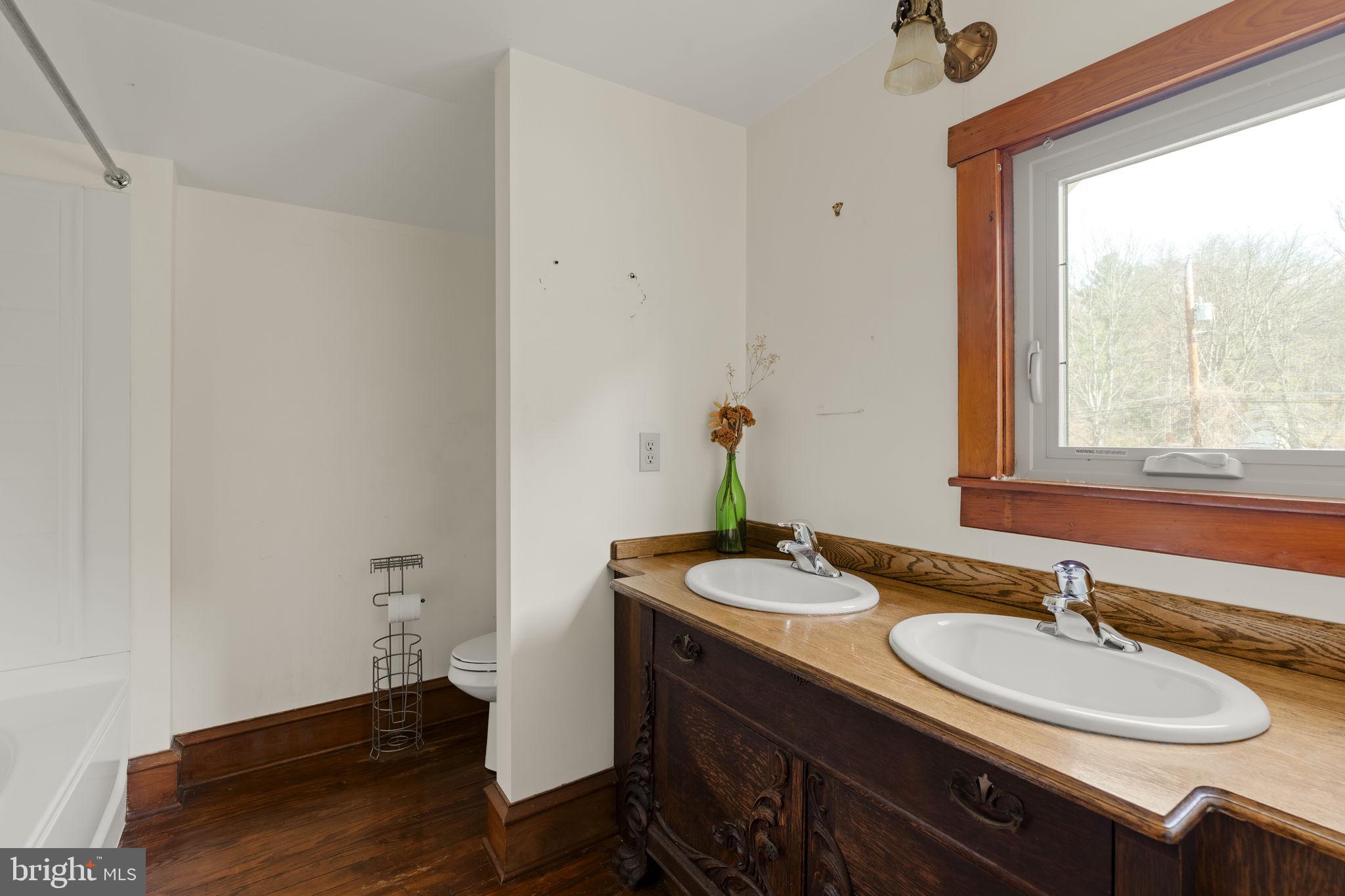451 Pine Swamp Road Elverson, PA 19520 - Photo 36 of 91 a bathroom with a granite countertop sink and a mirror