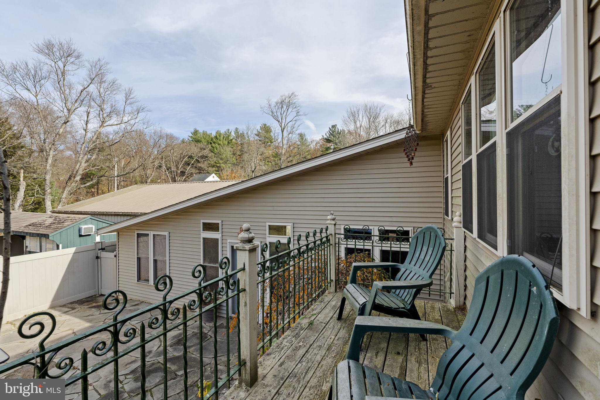 451 Pine Swamp Road Elverson, PA 19520 - Photo 70 of 91 a view of a roof deck with furniture and wooden floor