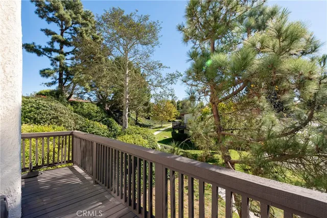 a view of a balcony with wooden fence