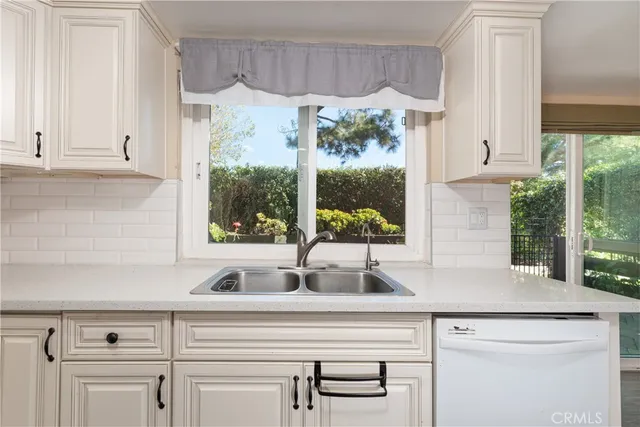 a kitchen with a sink and large window