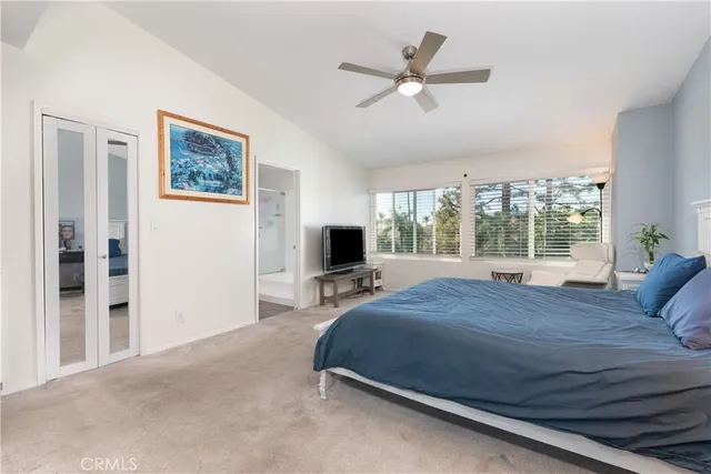 a bedroom with a bed a window and a chandelier