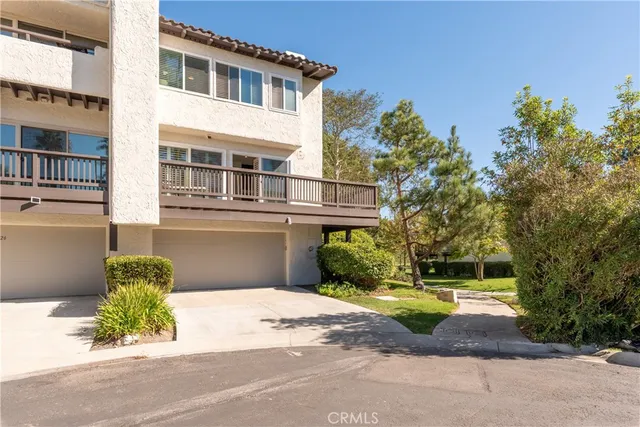 a front view of a house with a yard and a garage