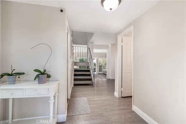 a view of an entryway with wooden floor