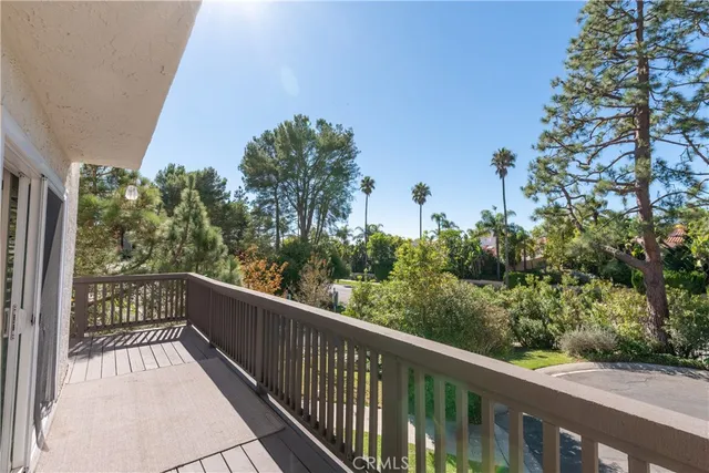 a view of a balcony with wooden fence and floor