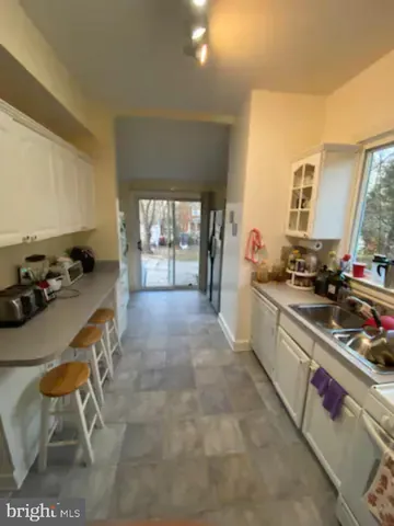 a kitchen with a sink and a stove top oven