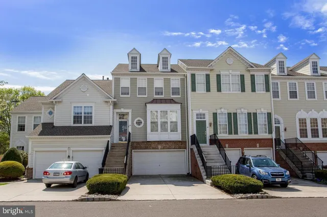 a front view of a house with parking space