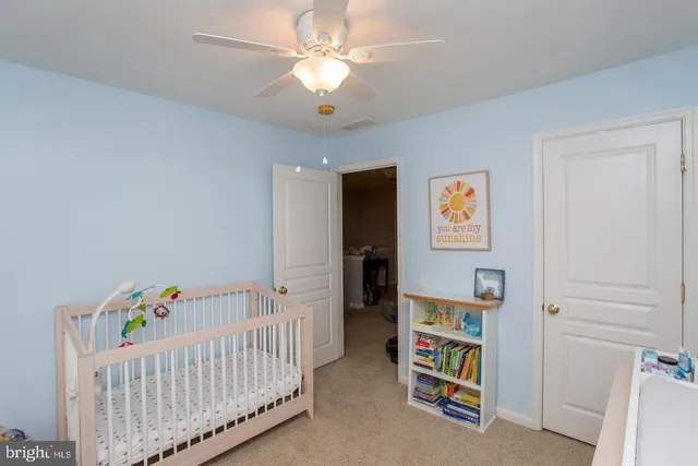 a bedroom with furniture and baby crib