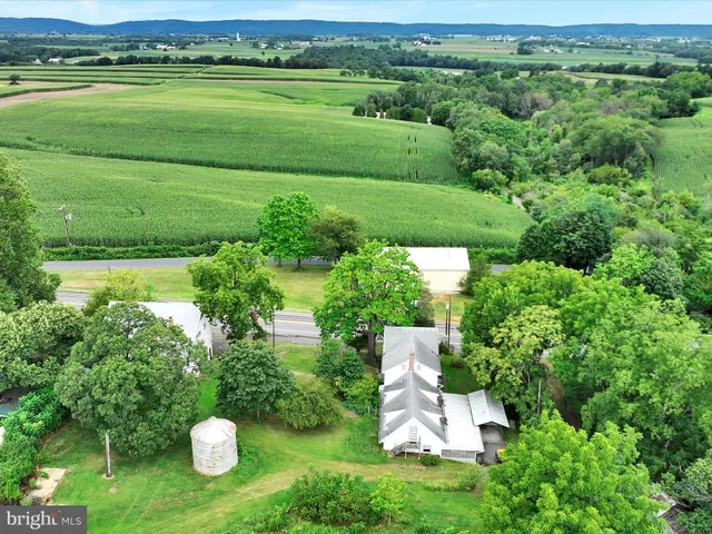 a view of a table and chairs in a garden