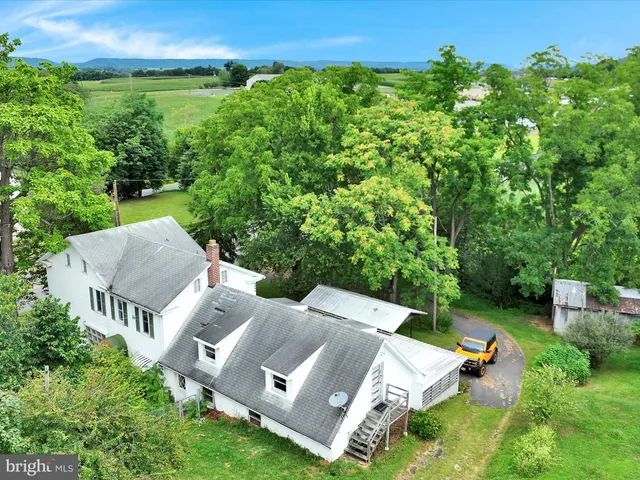 an aerial view of a house with yard and outdoor seating