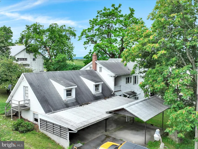 a view of backyard with a deck and wooden fence
