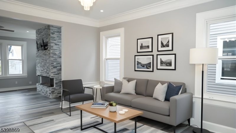 65 Poe Avenue Newark, NJ 07106 - Photo 11 of 18 a living room with furniture a couch and a window