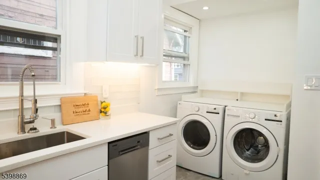 a utility room with sink dryer and washer