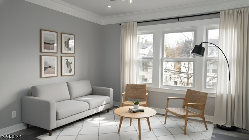 65 Poe Avenue Newark, NJ 07106 - Photo 12 of 18 a living room with furniture and a large window
