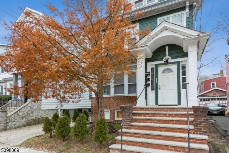 65 Poe Avenue Newark, NJ 07106 - Photo 15 of 18 a front view of a house with a yard