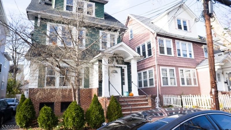 65 Poe Avenue Newark, NJ 07106 - Photo 16 of 18 a front view of a residential apartment building with a yard