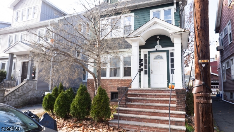 65 Poe Avenue Newark, NJ 07106 - Photo 17 of 18 a view of a brick house with a large windows and a table and chairs
