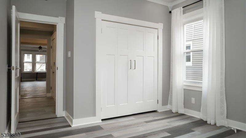 65 Poe Avenue Newark, NJ 07106 - Photo 3 of 18 a view of empty room with wooden floor
