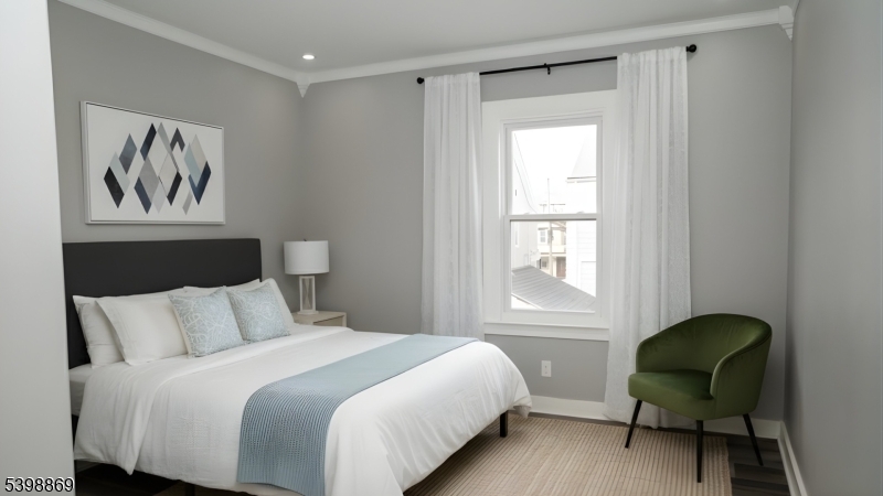 65 Poe Avenue Newark, NJ 07106 - Photo 4 of 18 a bedroom with a bed and a window