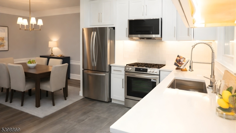 65 Poe Avenue Newark, NJ 07106 - Photo 10 of 18 a kitchen with a microwave a stove and a refrigerator