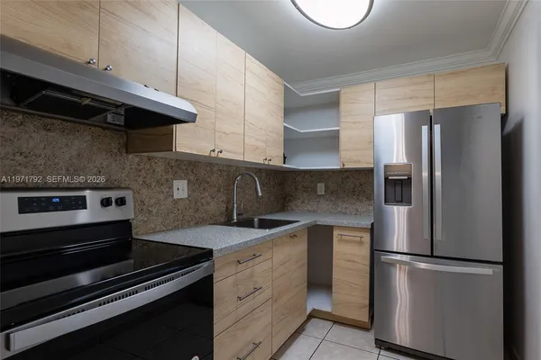 a kitchen with a refrigerator stove and cabinets