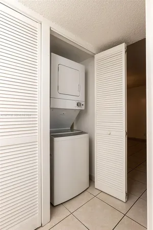 a utility room with closet dryer and washer
