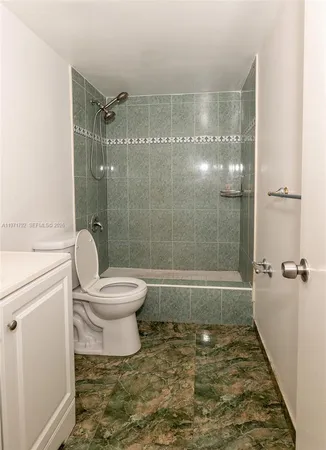 a bathroom with a toilet and a shower