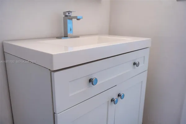 a bathroom with a sink toilet and mirror