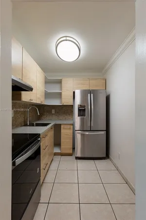 a kitchen with a stove sink and refrigerator