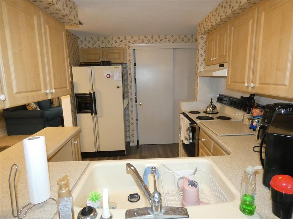 4392 Craftsbury Drive New Port Richey, FL 34652 - Photo 8 of 41 a kitchen with a refrigerator and a stove