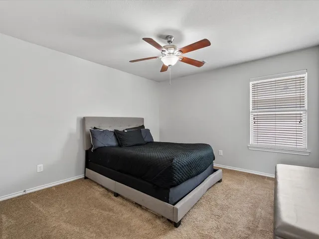 a living room with a bed furniture and a window