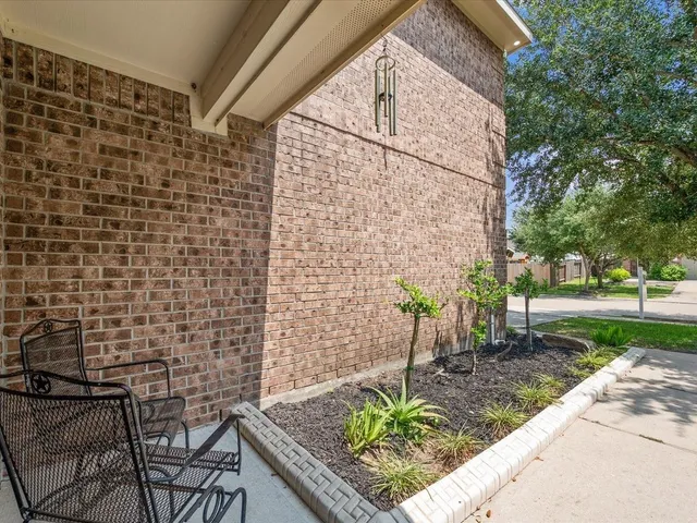 a view of a bench in patio of a house