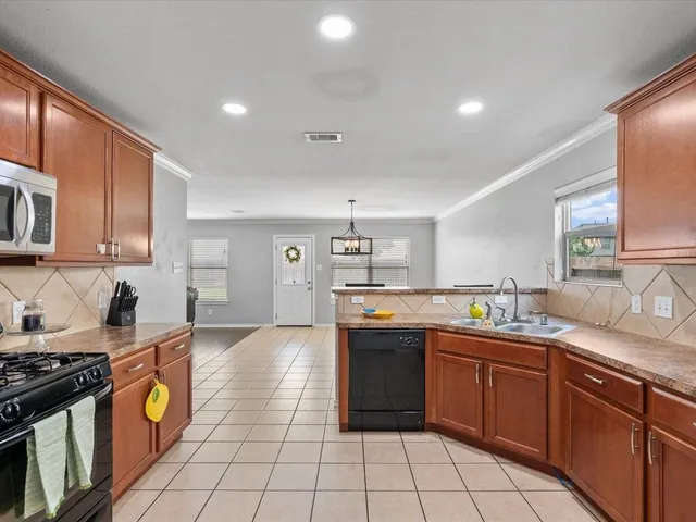 a kitchen with stainless steel appliances granite countertop a sink and cabinets