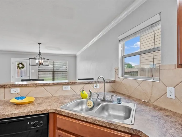 a kitchen with granite countertop a sink and a window