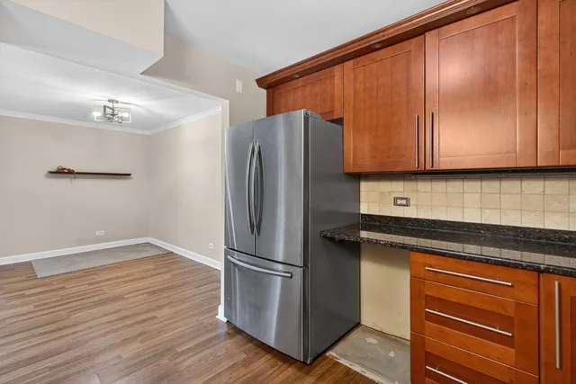 a kitchen with metallic refrigerator and cabinet