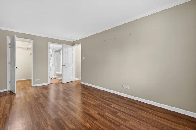 a view of an empty room and wooden floor