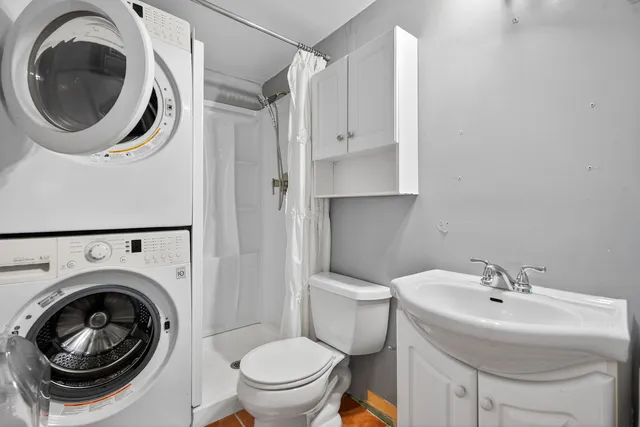 a bathroom with a sink mirror and toilet