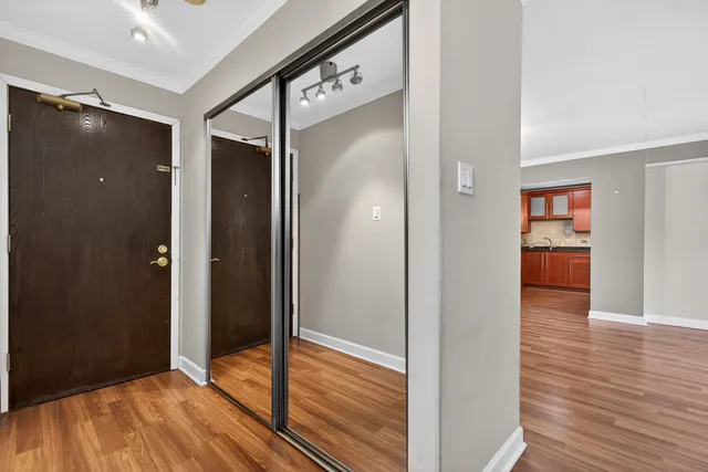 a view of a hallway with wooden floor