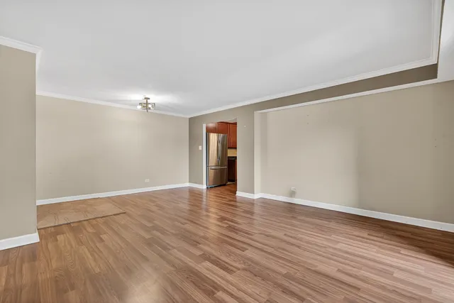 a view of an empty room with wooden floor