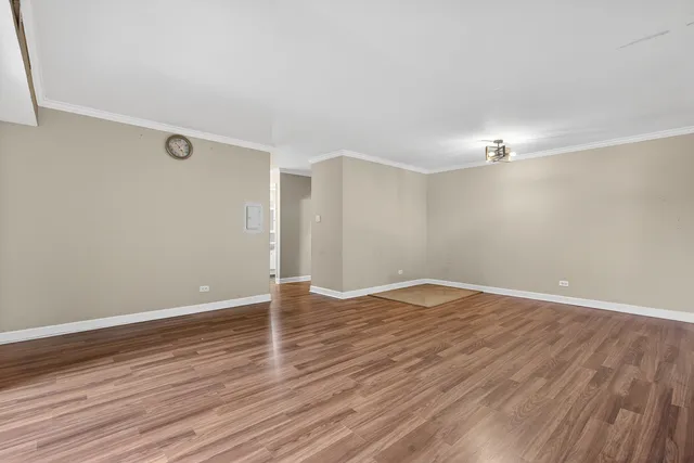 a view of a room with wooden floor