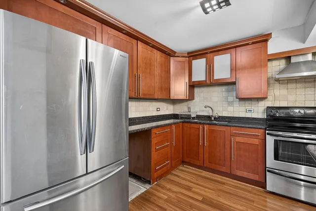 a kitchen with stainless steel appliances granite countertop a refrigerator sink and cabinets
