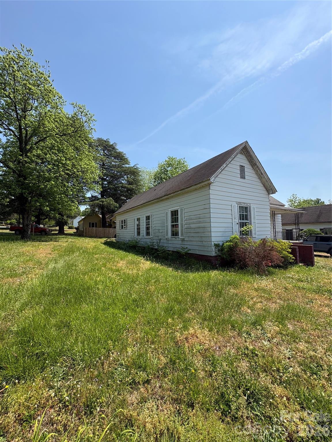 113 Davie Street Cooleemee, NC 27014 - Photo 14 of 14 a front view of house with yard and trees in the background