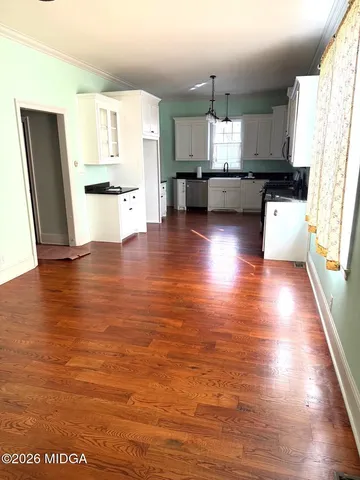 a kitchen with stainless steel appliances a refrigerator and wooden floor