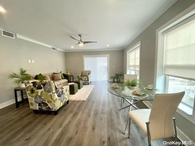a view of a dining room with furniture window and wooden floor