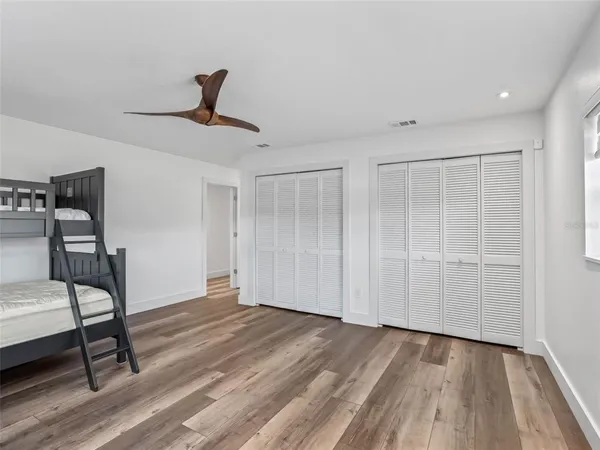 a view of an empty room with a window and a ceiling fan