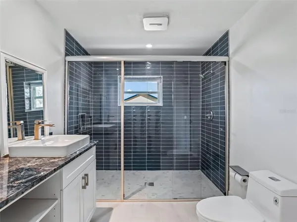 a view of a room with wooden floor and iron stairs