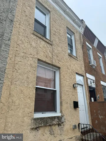 a brick house with a door and a yard